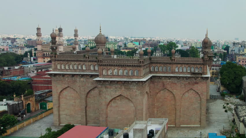 hyderabad mecca masjid to charminar reveal drone shot with crowded buildings aerial view