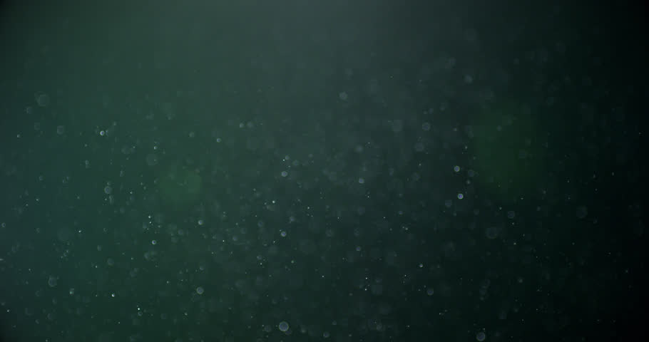 3D movie rendering of dust spheres, random slow motion particles in the air and close-up camera view.