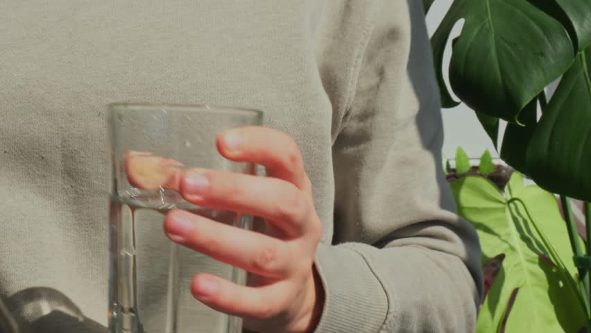 Pouring Organic blue-green algae spirulina detox drink in glass powder food. Health protein cocktail smoothie of chlorella. Vitamins and minerals to diet. Prebiotic and antioxidant rich Dietary