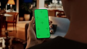 Chroma key, Black African-American man using his phone at home, camera travels into the smartphone screen. Evening shot, furnished house interior in the background - Powered by Shutterstock - Get 15% off with code: PIKWIZARD15