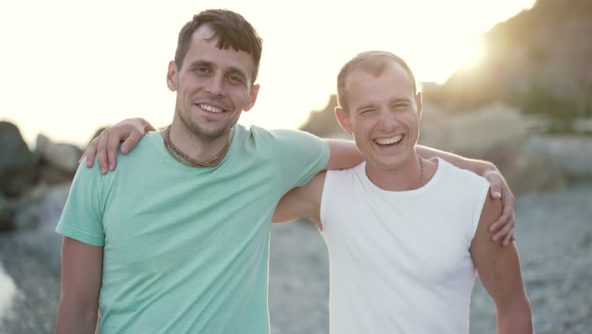 Two smiling best friends at the sunset