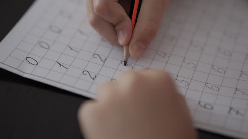 School Boy Practicing Writing Numbers at Home. Child Working on His Homework. Little Boy Studying Learning at Home. Child, Learning Doing Math for Education, Making Homework Numbers in His Room. Royalty-Free Stock Footage #1110401625