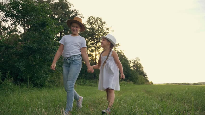 Happy family kids at sunset in the park. kids dream of walking in a green park in the fresh air of the countryside.