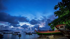 .time lapse colorful cloud moving above the marina of fishing boat at twilight..beautiful sky in nature and travel concept.4K resolution..scenery blue sky in sunrise on the islands background.