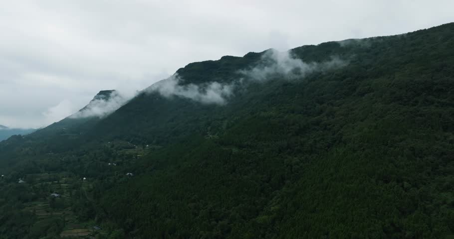 Aerial landscape of mountain forest with mist floating above the village | Shutterstock HD Video #1110413661