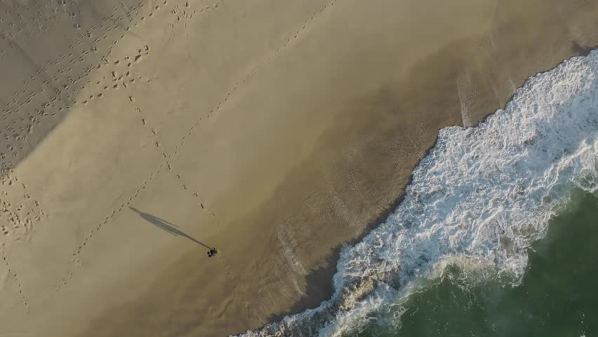 Aerial view of a person on Bronte beach at sunset, New South Wales, Sydney, Australia.