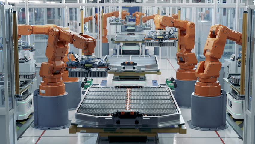 EV Battery Pack for Automotive Industry Assembled on Production Line with Orange Robotic Arms.  Automated Battery Manufacturing Line Equipped with Robot Arms. Electric Car Smart Factory