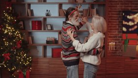 Elderly Retired People and Leisure Activities. Happy Senior Couple Dancing in the Living Room at Christmas. Senior Couple Enjoys Time Together at Home. Celebrating the Winter Holiday - Powered by Shutterstock - Get 15% off with code: PIKWIZARD15