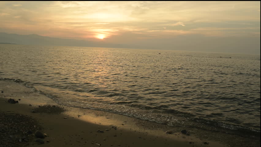evening sunset sun on the Mediterranean coast of the island of Cyprus, beach waves