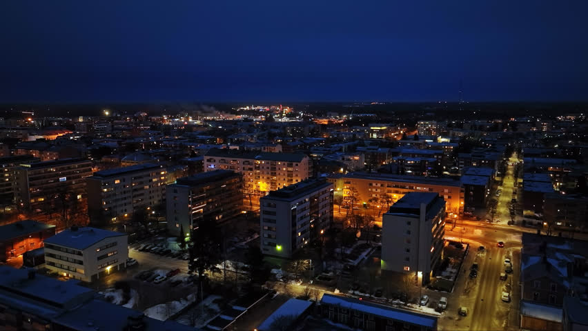 Aerial view around condos and illuminated streets of Vaasa, dusk in Finland