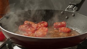 Fresh cherry tomatoes in a frying pan with olive oil and spices. Cooking tomato sauce. Traditional Italian Mexican Asian dish. High quality studio shot for cafe, restaurant close up. - Powered by Shutterstock - Get 15% off with code: PIKWIZARD15