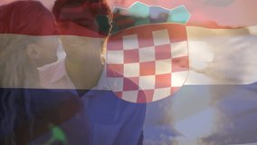 Composite video of waving croatia flag against caucasian couple embracing each other at the beach. Patriotism and motherhood concept