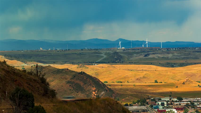 Rain clouds over the hills with construction site in the background, time-lapse, Denver, Colorado, 4K