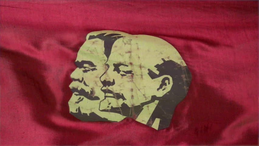 Close-up of a stylized portrait of Marx and Lenin on a red satin parade banner of the Soviet Union.