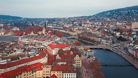 Aerial drone footage of Zurich old town and downtown along the Limmat river and lake Zurich in Switzerland largest city