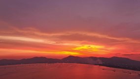 
aerial hyperlapse view amazing red sky in colorful sky above the island.
Majestic sunset or sunrise landscape Amazing light of nature background. 
gradient color texture fantastic sky texture.