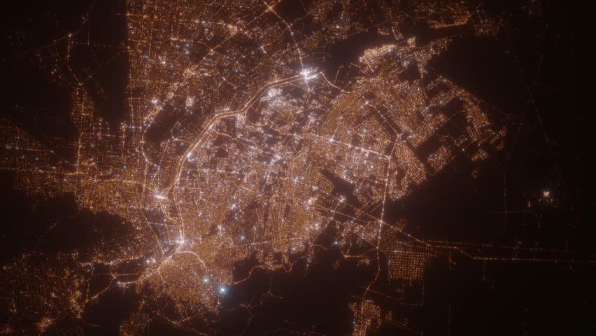 Ciudad Juarez (Mexico) top view at night. Top view on modern city with street lights and glow effect. Camera is zooming in, rotating clockwise. Vertical video. The north is on the left side