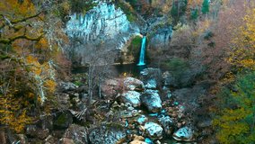 Man watching water coming naturally through the mountains. The man in the yellow coat. The drone is heading towards Ilica Waterfall. Kastamonu, Turkey.