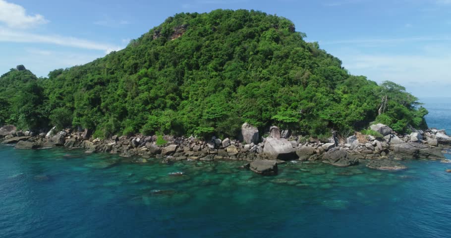 Tropical blue water of Viet Nam Sea ocean sunny beautifu waters. Flying drone arial shot rocky and sandy beaches and beautiful waves. Perfect holiday travel exotic destination Tho Chu Island
