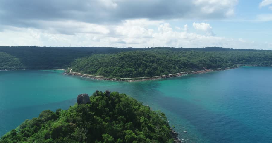 Tropical blue water of Viet Nam Sea ocean sunny beautifu waters. Flying drone arial shot rocky and sandy beaches and beautiful waves. Perfect holiday travel exotic destination Tho Chu Island