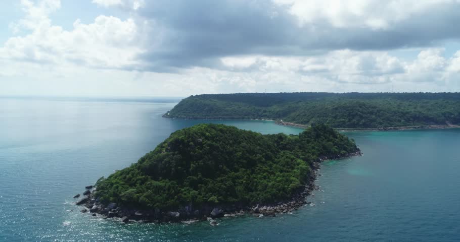 Tropical blue water of Viet Nam Sea ocean sunny beautifu waters. Flying drone arial shot rocky and sandy beaches and beautiful waves. Perfect holiday travel exotic destination Tho Chu Island