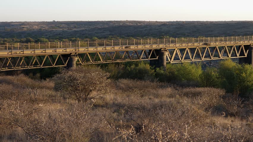 Quick pan across wide span of old wagon bridge near Hopetown, RSA