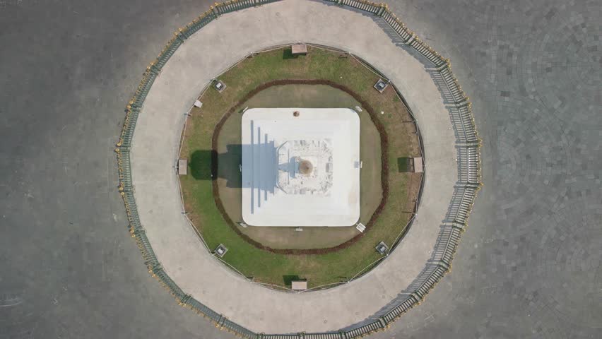 Tugu monument in Yogyakarta with street traffic, aerial top down view