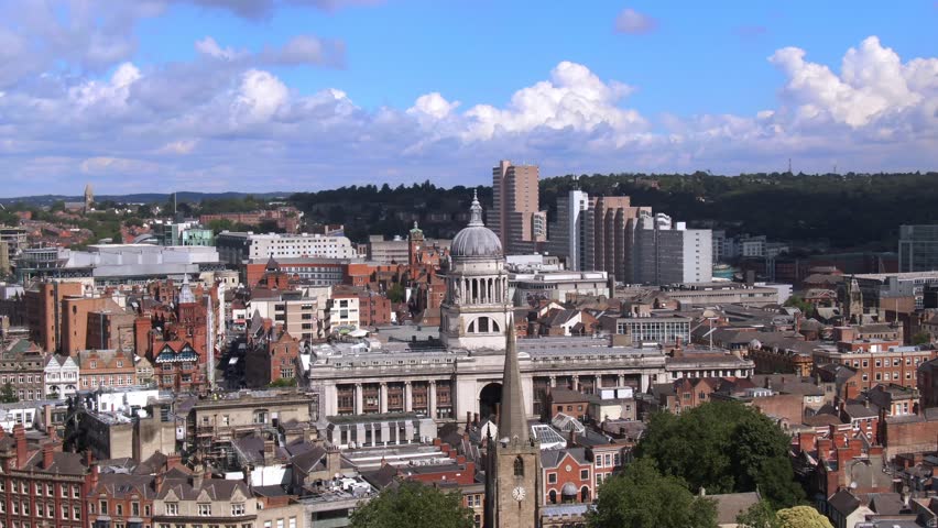 Dynamic aerial view over city centre of Nottingham England. Nottingham council house in focus.
