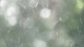 Raindrops fall onto a car's glass window. macro or closeup video.