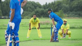 Indian Cricket Teams Training Before a Match in a Field. Blue Team Batter Successfully Hitting the Ball and Sprinting to Score a Run. Yellow Team is Eager to Catch the Ball - Powered by Shutterstock - Get 15% off with code: PIKWIZARD15