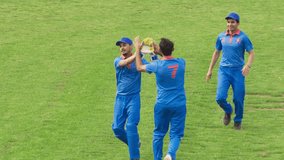 TV Match of Professional Cricket Game Playback Montage. Professional Teams Throw and Hit the Ball. Athletes Scoring Runs, Celebrating. Real-Time Live Match with Slow Motion Replays - Powered by Shutterstock - Get 15% off with code: PIKWIZARD15