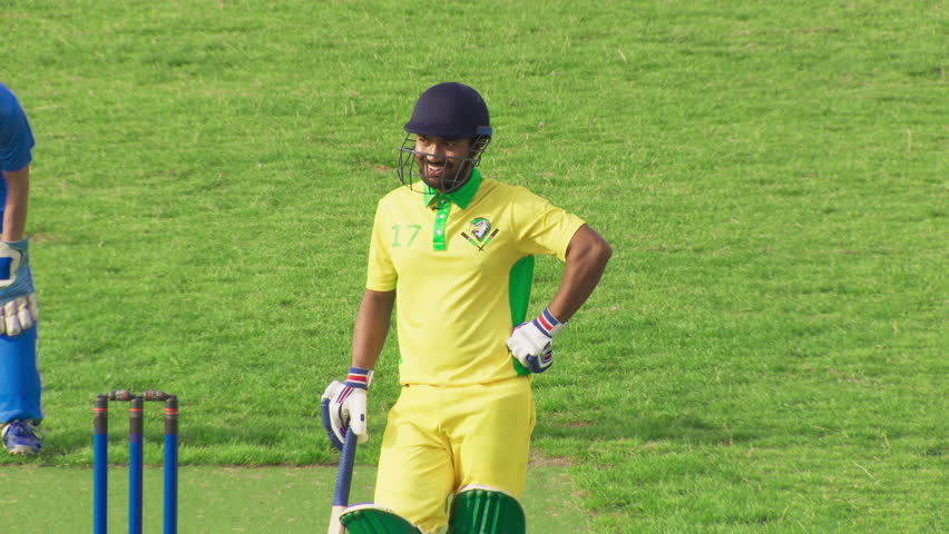 Cheerful Indian Batter Preparing to Take a Swing. Batsman Holding a Bat, Focused on the Bowler. TV Match of Professional Cricket Game. Sport Broadcast Channel Television Playback