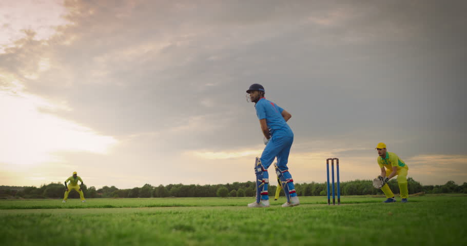 Professional Indian Teams Playing a Practice Match of Cricket. Blue Team Batsman Hitting the Ball, Running to Other Side of the Pitch. Yellow Team Stops the Opponent, Celebrates a Successful Game Royalty-Free Stock Footage #1110455163