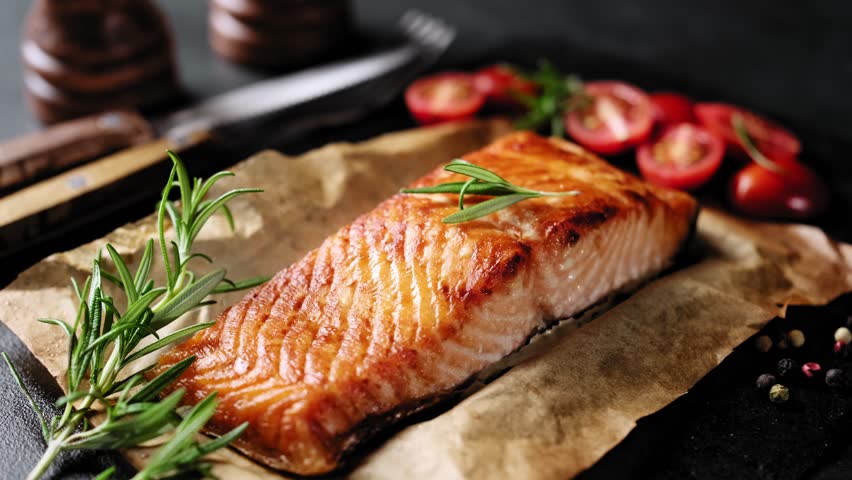 Salmon or trout fillet grilled or roasted or baked in the oven. Healthy seafood, cooked red fish, stock video 4k footage. 