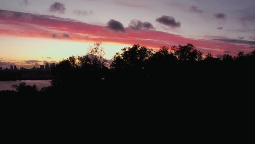 Aerial panoramic view of the beautiful city of Perth at picturesque and dramatic red and purple hues sunset. Aerial view of the Perth skyline and Swan River in Western Australia.