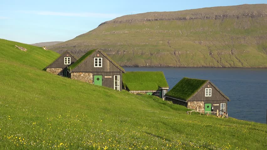 Faroe islands - july.16.2023 - lakeside homes on the faroe islands have grass roofs. | Shutterstock HD Video #1110477263
