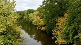 Aerial drone footage of college campus on a cloudy fall day in October in East Lansing Michigan near the red cedar river. College dorms, apartments and classes visible