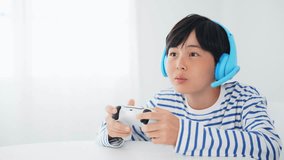 Boy playing video games while voice chatting.