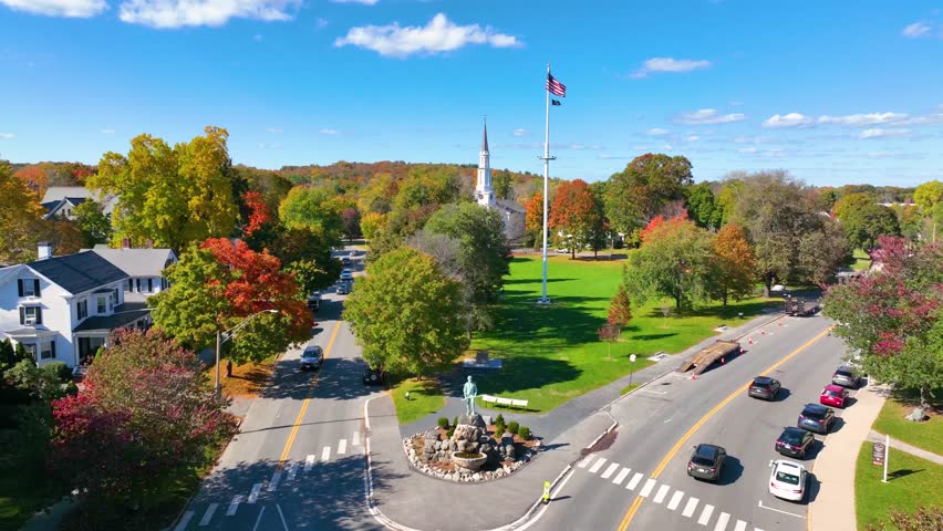 Lexington Minuteman Statue aerial view in fall on Lexington Common with First Parish Church, town of Lexington, Massachusetts MA, USA. 