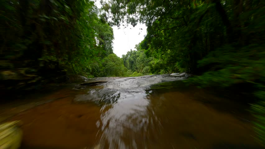 FPV flight over tropical river in rainforest in Thailand.