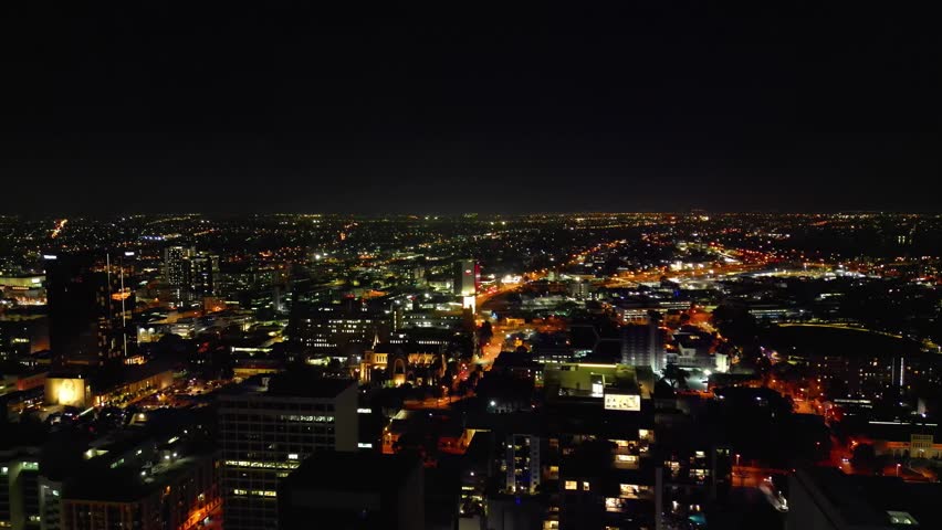 Aerial flyover illuminated City of Perth with skyline at night in Australia Royalty-Free Stock Footage #1110498763