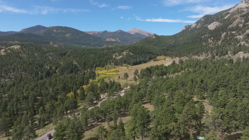 Aerial landscape of Rocky Mountain National Park, Colorado. Evergreen forest and blue sky.