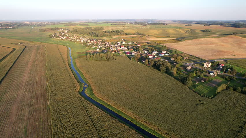 Rural landscape. Country houses in countryside. Village Home in Country. Wooden house in Russian village. Agricultural field with Suburban house. Rural building in countryside. Roofs of village home