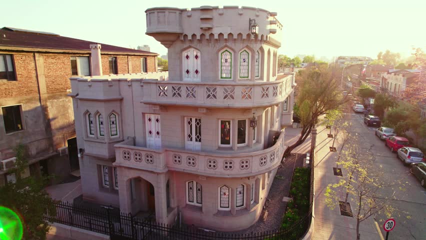 Dolly in establishing of the front of the Sermini Castle in a residential neighborhood of Providencia, Santiago Chile with the rays of the nostalgic sunset.