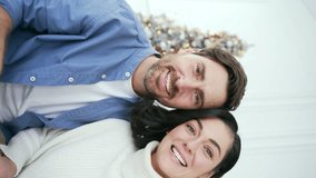 POV Webcam view Vertical video. Happy family couple communicates on a video call at home during winter New Year Christmas Xmas holidays. Smiling wife and husband talking wishes, congratulates remotely - Powered by Shutterstock - Get 15% off with code: PIKWIZARD15