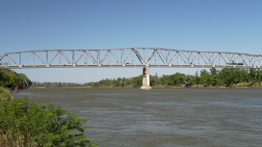 traffic on a truss bridge over the Missouri River at Brownville, Nebraska, windy early fall scenery Royalty-Free Stock Footage #1110512255