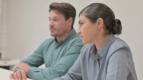 Mixed Race Couple Talking in Office