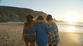 Three best friends walk on sunny beach at sunset. Happy laughing women, hug and put arms around each other. Female empowerment and bonding, mutual support concept - Powered by Shutterstock - Get 15% off with code: PIKWIZARD15