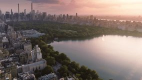 Green urban Central park aerial. 4K epic panorama of Manhattan. New York city downtown background. Urban park summer travel. Epic pink sunset above Central park. Scenic lake reflecting beautiful sky