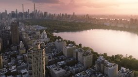 Green urban Central park aerial. 4K epic panorama of Manhattan. New York city downtown background. Urban park summer travel. Epic pink sunset above Central park. Scenic lake reflecting beautiful sky - Powered by Shutterstock - Get 15% off with code: PIKWIZARD15